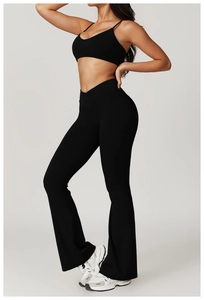 Detail view of black flare yoga leggings and deep V-neck sports bra on model