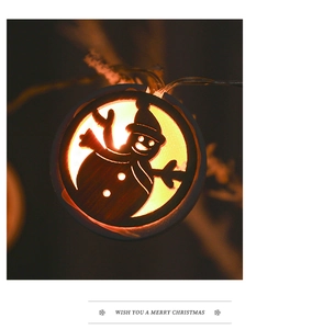 Macro shot of Nordic wooden LED Christmas ornament with warm snowman silhouette detail