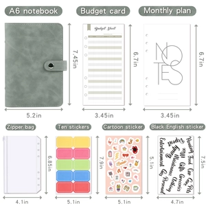 Detailed flat lay of A6 sage green PU leather binder with labeled zipper bags and stickers