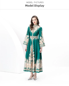 Detail of vintage palace style dark green maxi dress with baroque gold floral prints