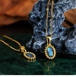Detail of bohemian gold stainless steel necklace with oval abalone shell pendant on stone