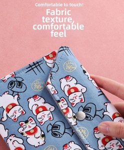Detail of light blue Japanese Maneki-neko textured leather wallet with metal snap closure