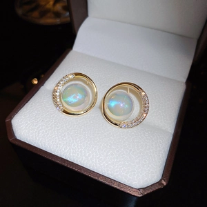 Macro view of gold plated hoop earrings with iridescent pearls and cubic zirconia