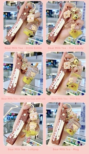 Detail view showing six creative bear bubble tea keychain styles with liquid and pearls