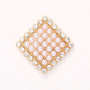 Elegant gold alloy brooch with pink pearls and sparkling crystal border on white background