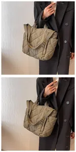 Detailed macro view of quilted puffer tote bag with diamond stitching and broad strap