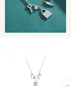 Detail view of S925 silver paperclip chain necklace with sparkling lock and key pendants