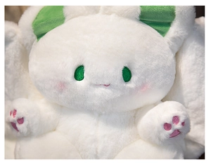 Close-up of white plush bunny head with soft green ear lining and pink paw details