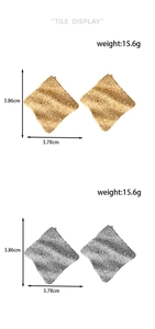 Detailed view of large square textured earrings with dimensions 3.86cm and weight 15.6g