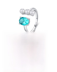 Detail of S925 sterling silver ring featuring three pearls and a teal blue oval crystal