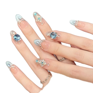 Handmade light blue gradient press-on nails with luxury rhinestones and 3D floral accents