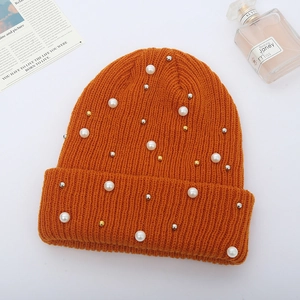 Orange ribbed knit beanie for women with elegant faux pearl and metal bead embellishments