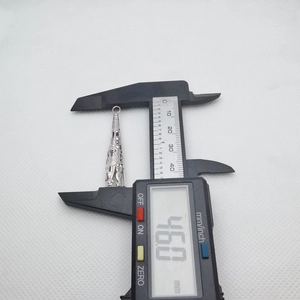 Macro view of 46mm silver hollow pendant measuring length with digital caliper