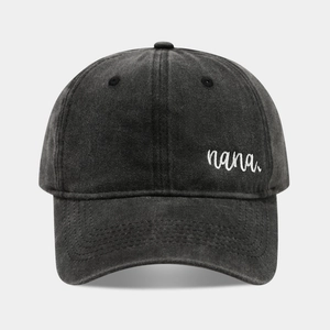 Close-up of white nana embroidery on washed cotton fabric of the baseball cap
