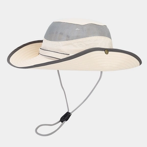 Detail view of breathable mesh crown and windproof rope on the beige outdoor hat