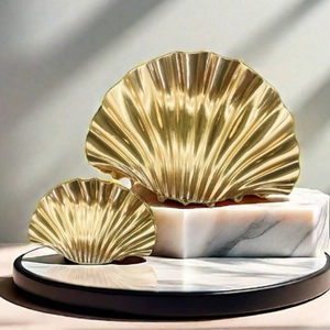 Detailed close-up of golden shell hair clips on marble stand for elegant beach hairstyles