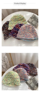 Detailed macro view of the colorful chunky knit texture and mixed yarn pattern on beanies