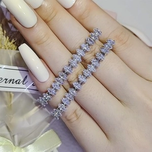 Macro shot of silver rings with marquise-cut marquise stones on a model's hand