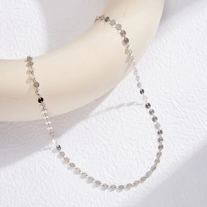 Minimalist S925 sterling silver necklace with connected polished round discs on a beige stand