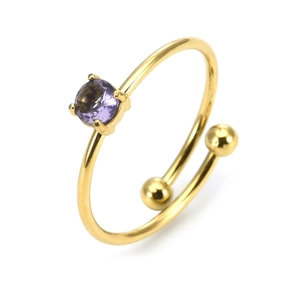 Detail of adjustable gold ring featuring a round purple gemstone and dual ball ends