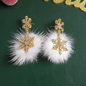 Winter snowflake drop earrings with white pompom and rhinestones on dark background