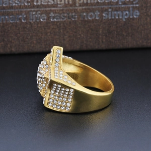 Macro side view of luxury gold-plated men's star ring with iced-out micro-pave crystals