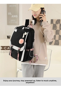 Detail of waterproof black and white backpack with pink sport strap and pompom charm