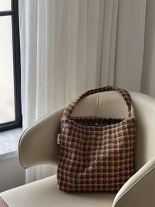 Detail of vintage houndstooth knit shoulder bag featuring simple wish brand label