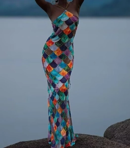Detail of colorful mermaid scale print on a slim fit halter neck backless maxi dress