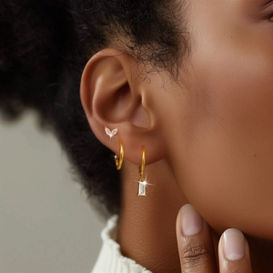 Close-up of S925 silver gold-plated earring set with marquise and emerald-cut zircon stones
