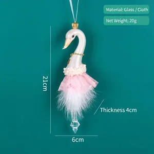 Detail of swan ornament with pink tutu, white feathers and glass pendant for Christmas tree