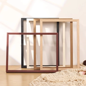 Minimalist solid wood picture frames in various colors with elegant shadow lighting