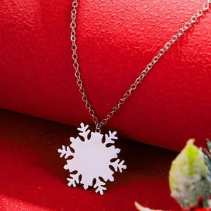 Silver snowflake pendant necklace on a red textured background with a fine link chain