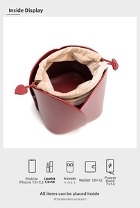 Top view of red tulip petal bucket bag showing the beige drawstring liner and interior storage