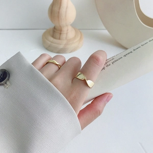 Minimalist S925 sterling silver Mobius twist rings in gold finish worn by a model