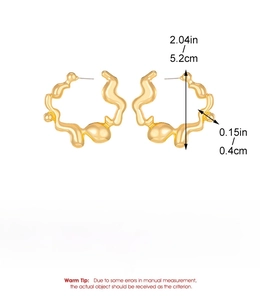 Detailed view of large gold liquid wave hoop earring with 5.2cm diameter and alloy specs