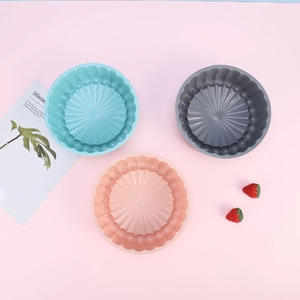 Detailed view of sunflower silicone cake molds in blue, grey, and pink pastel colors