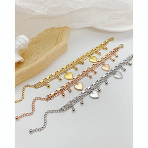 Chunky layered stainless steel heart bracelets in gold, silver, and rose gold finish