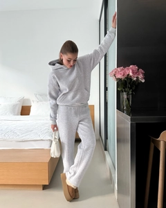 Close-up of light grey two-piece hooded sweatshirt and jogger set with soft knit texture