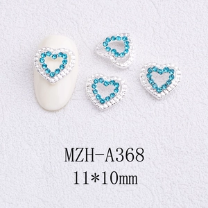 Detail view of 11x10mm heart-shaped nail art charms with lake blue and clear rhinestones