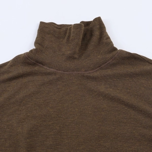 Detail of dark brown high collar knit top with fine stitching and smooth fabric texture