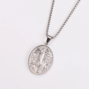 Macro shot of silver Virgin Mary relief pendant on a box chain for a vintage look