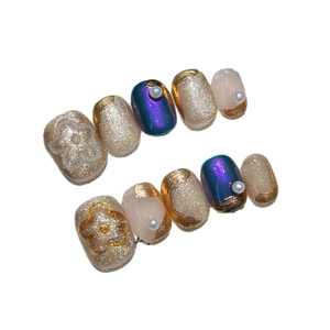Handmade press-on nails with luxury gold edges, purple cat-eye effect and 3D floral accents