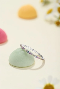 Macro shot of silver stackable ring with multi-color rainbow cubic zirconia gems
