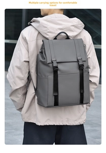 Close-up of a minimalist dark gray commute backpack with waterproof matte fabric and buckles