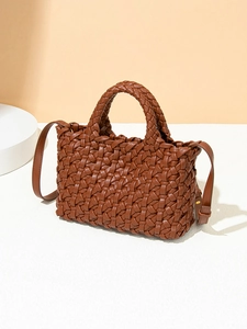 Brown hand-woven leather tote bag with circular handles and a stylish crossbody strap