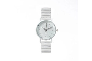 Minimalist white watch detail showing round dial and elastic textured band strap
