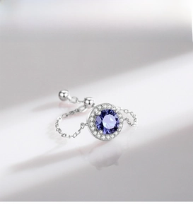 Macro detail of S925 silver adjustable chain ring featuring purple halo-set gemstone