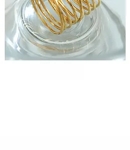 Detailed view of multilayer golden spiral ring with minimalist wrap-around metal wire design