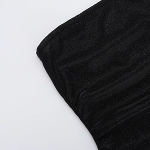 Detailed close-up of sparkly black fabric texture for elegant slit tube dress